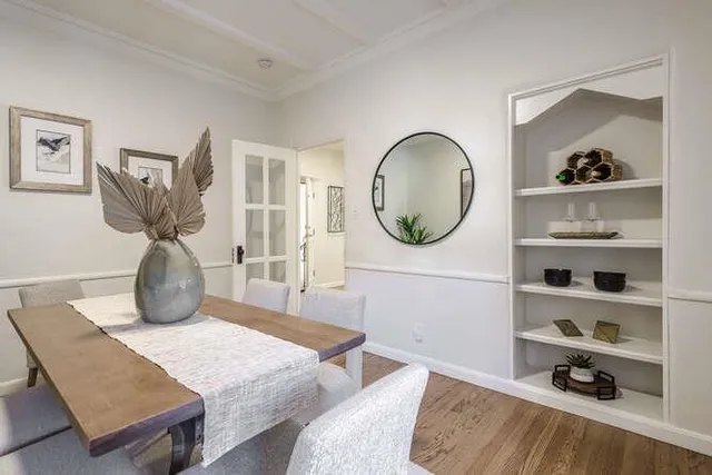 a bedroom with a bed a mirror and shelf