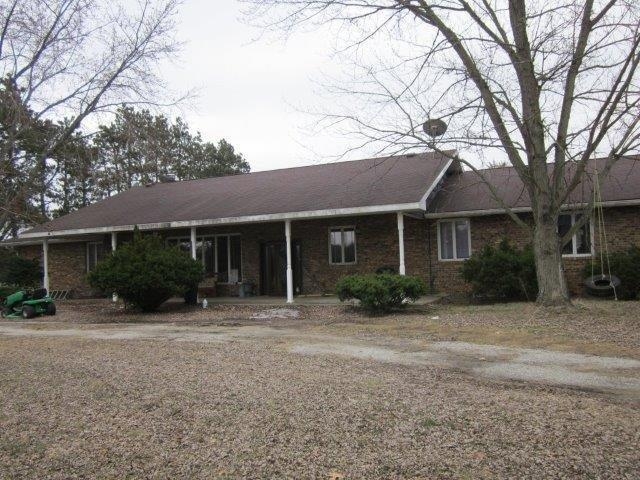 10095 East State Road Knox, IN 46534 - Photo 4 of 7 a front view of a house with a yard and potted plants
