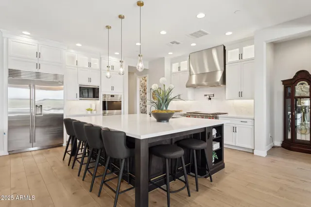 a large kitchen with a table and chairs