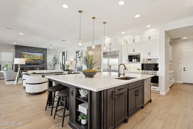 a large kitchen with kitchen island a sink table and chairs