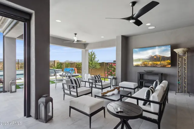 a view of a patio with couches and potted plants with sky view