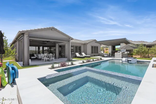 a view of a house with a yard and sitting area