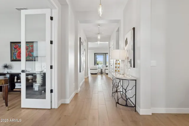 a view of a hallway with wooden floor windows and livingroom