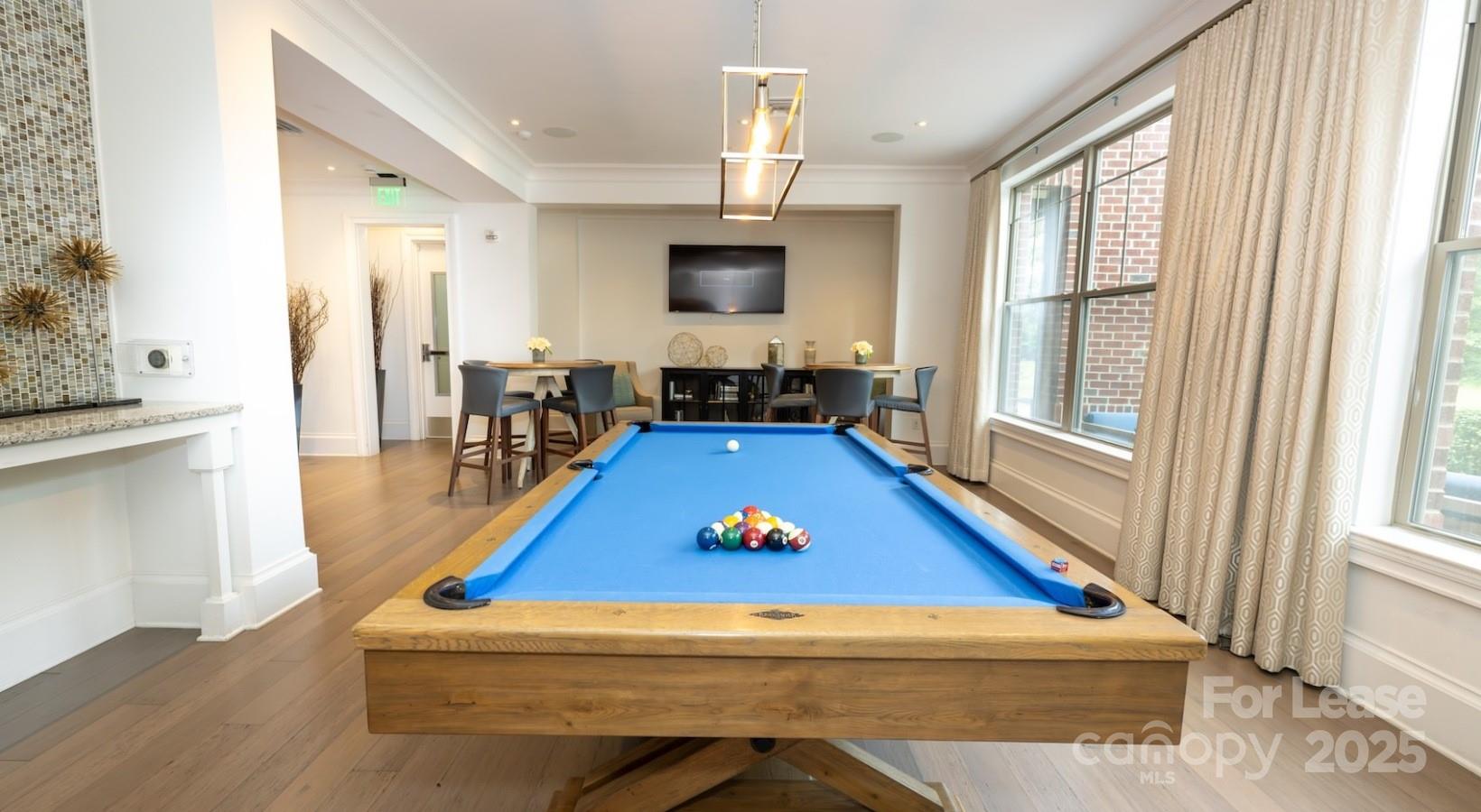 10624 Parrish Street, Unit A1 Matthews, NC 28105 - Photo 14 of 42 a living room with pool table flat screen tv and windows