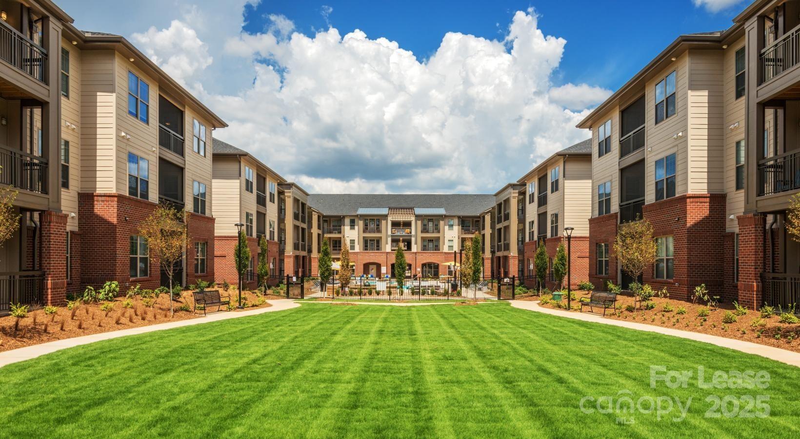10624 Parrish Street, Unit A1 Matthews, NC 28105 - Photo 19 of 42 a view of a building with a yard