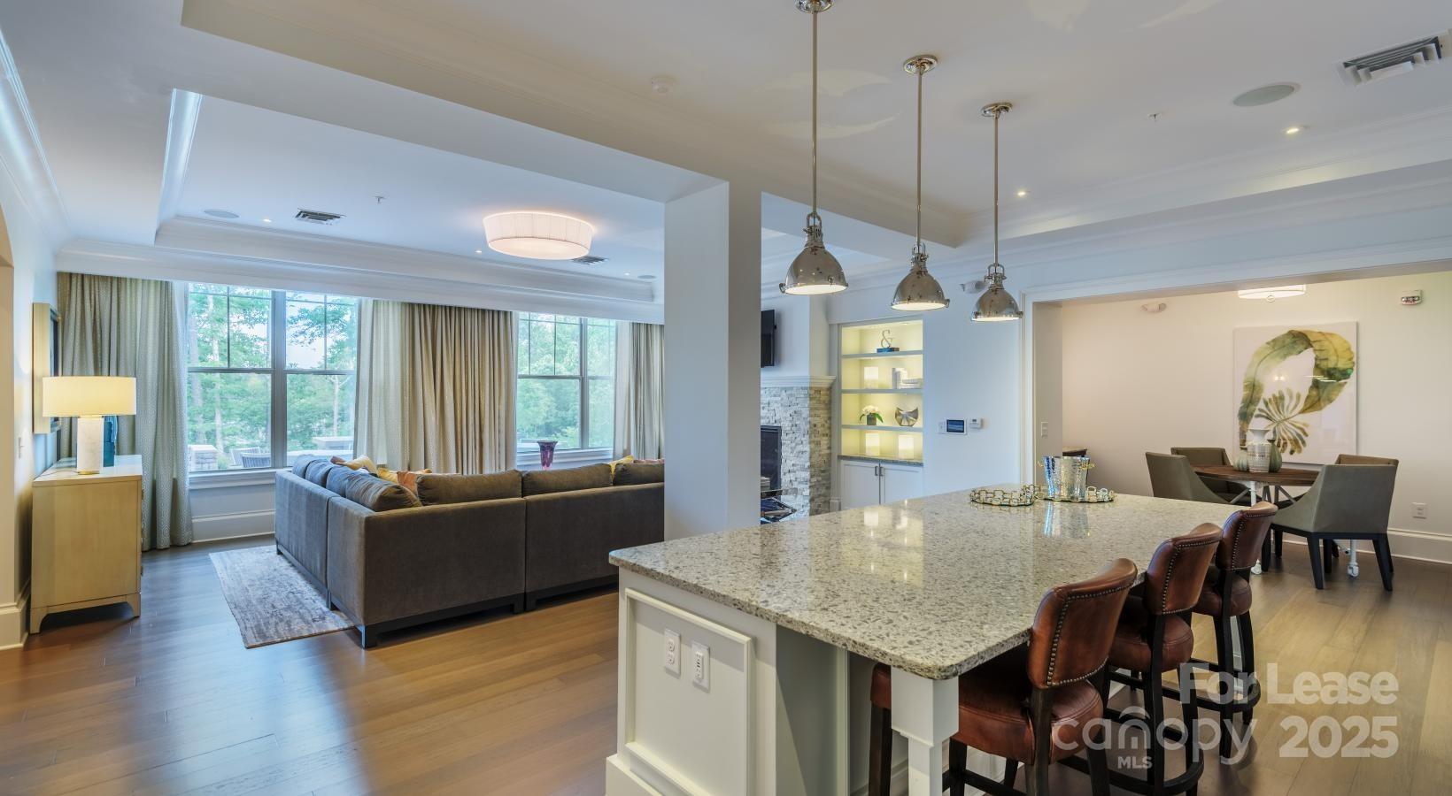 10624 Parrish Street, Unit A1 Matthews, NC 28105 - Photo 24 of 42 a view of a dining room with furniture window and wooden floor