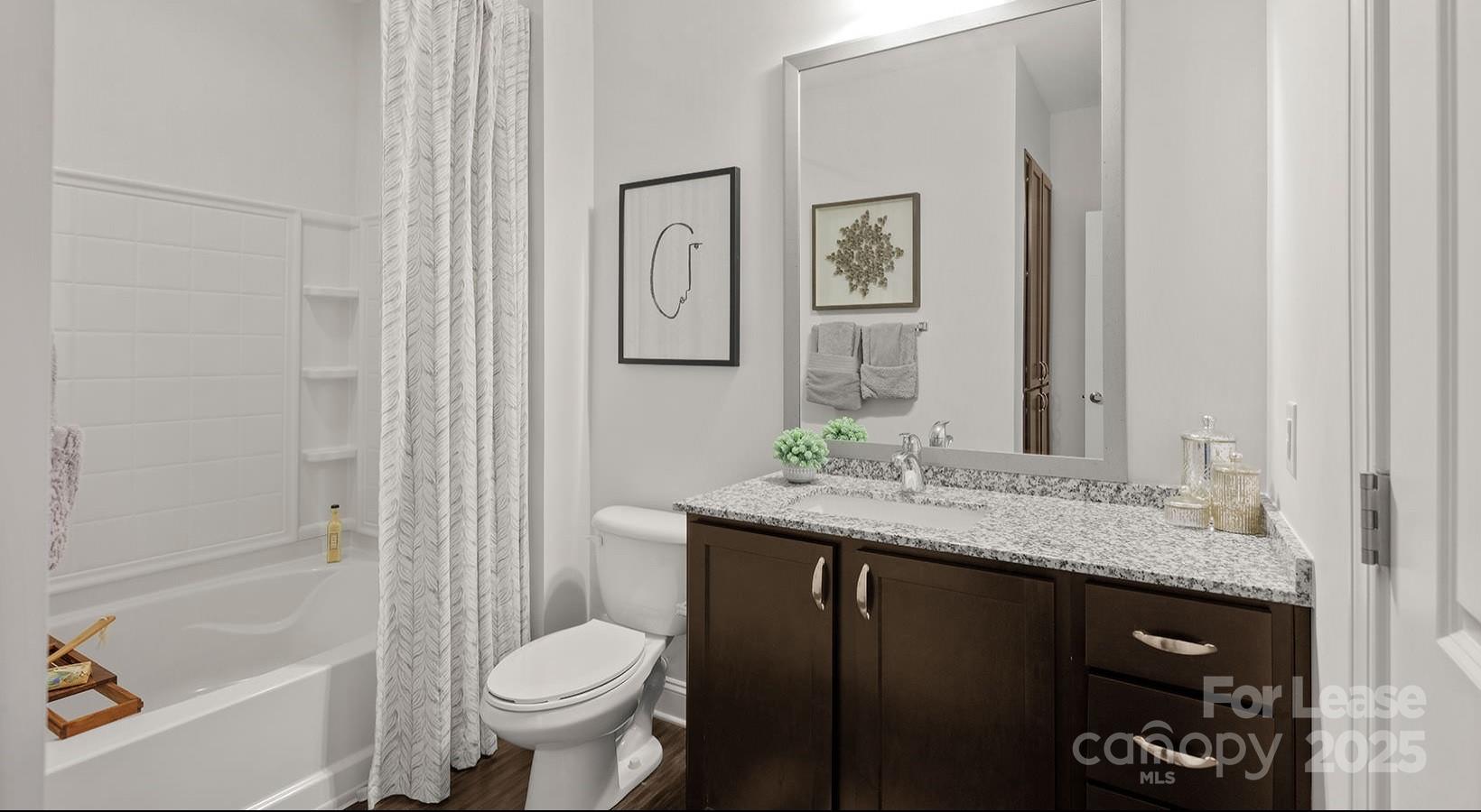 10624 Parrish Street, Unit A1 Matthews, NC 28105 - Photo 37 of 42 a bathroom with a granite countertop sink toilet and shower