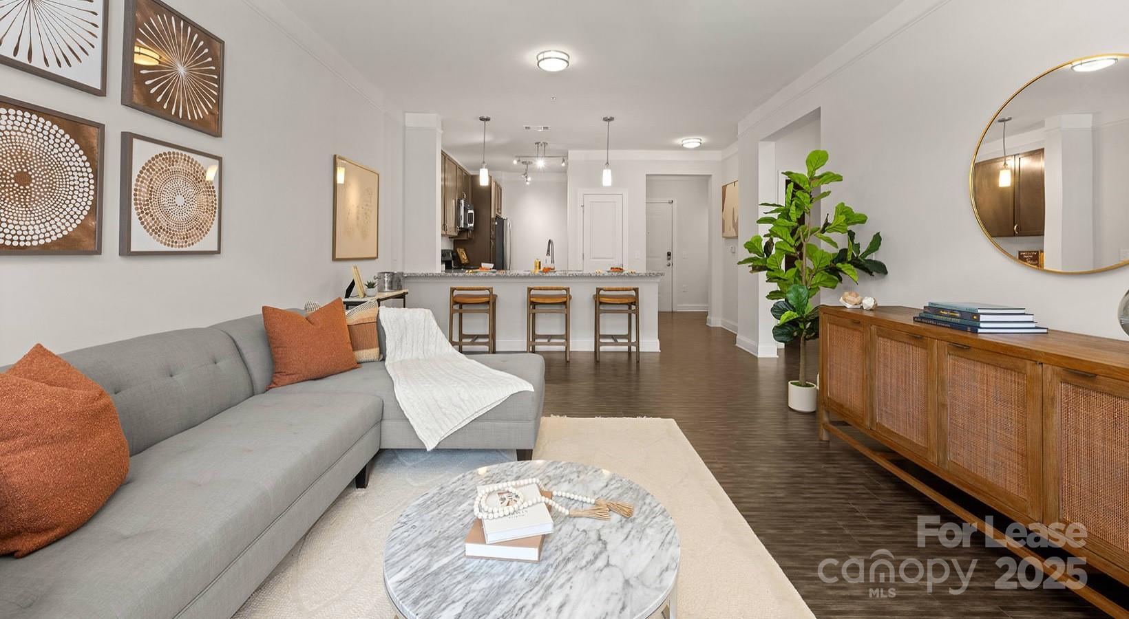 10624 Parrish Street, Unit A1 Matthews, NC 28105 - Photo 41 of 42 a living room with furniture and a wooden floor