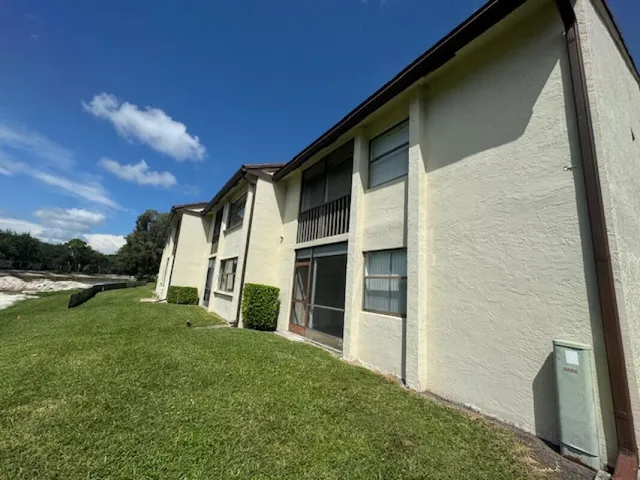 a view of an house with backyard porch and garden