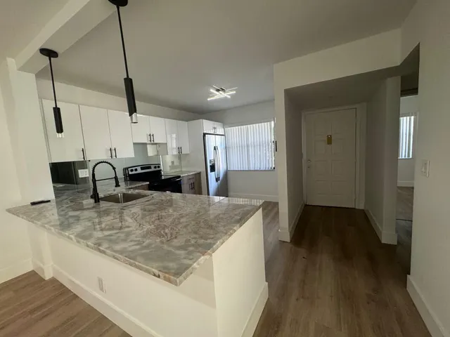 a kitchen with sink and refrigerator