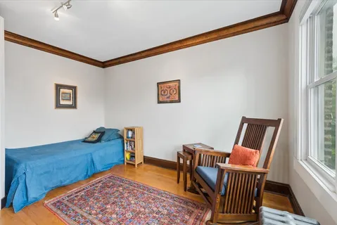 a living room with furniture a rug and a window