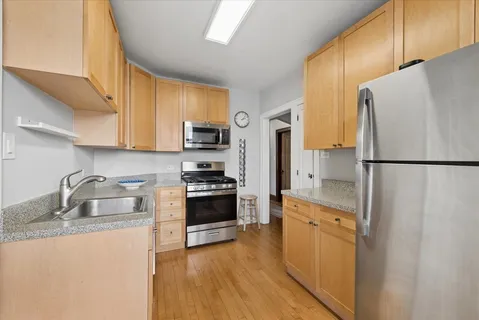 a kitchen with stainless steel appliances a refrigerator stove microwave and sink
