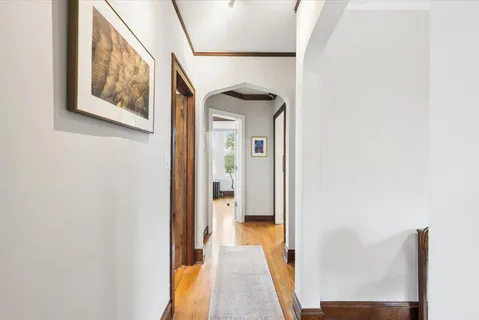 a view of a hallway with wooden floor