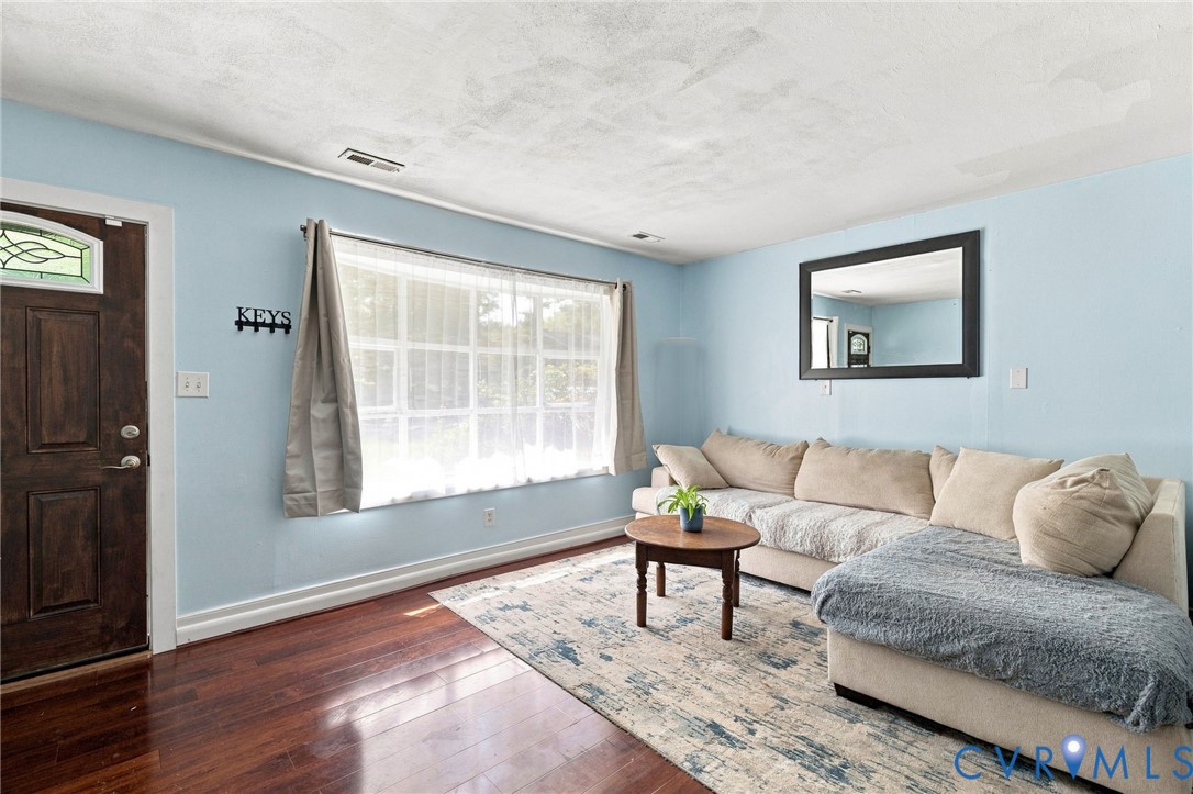Hardwood-style flooring, large window with natural