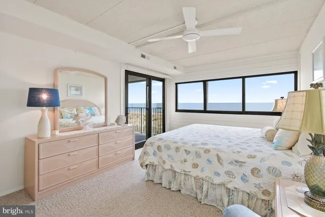 a bedroom with a large bed and a large window