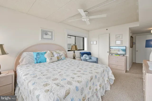 a bathroom with a granite countertop toilet sink and mirror