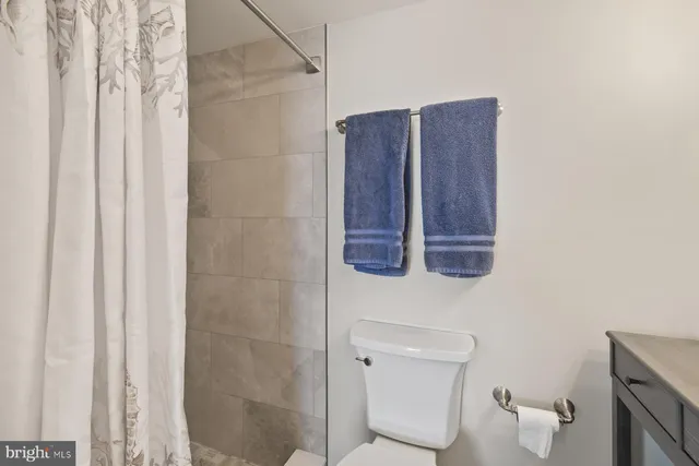 a bathroom with a double vanity sink mirror and shower