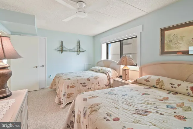 a bedroom with a bed and a lamp