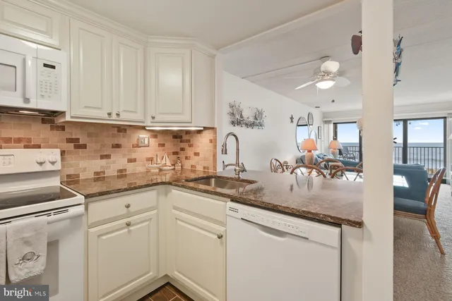 a kitchen with appliances cabinets and furniture