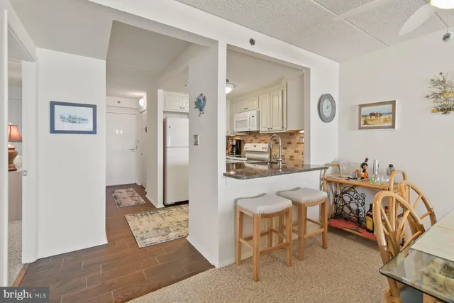 a view of a dining room with furniture and a chandelier