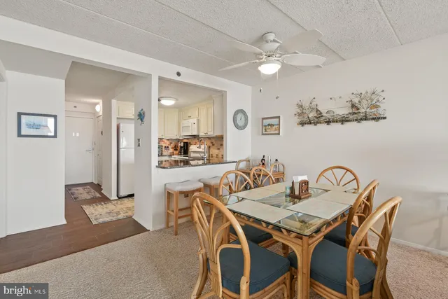a view of a dining room with furniture and a livingroom