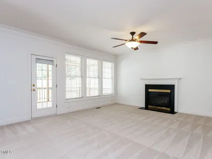 a view of empty room with a fireplace