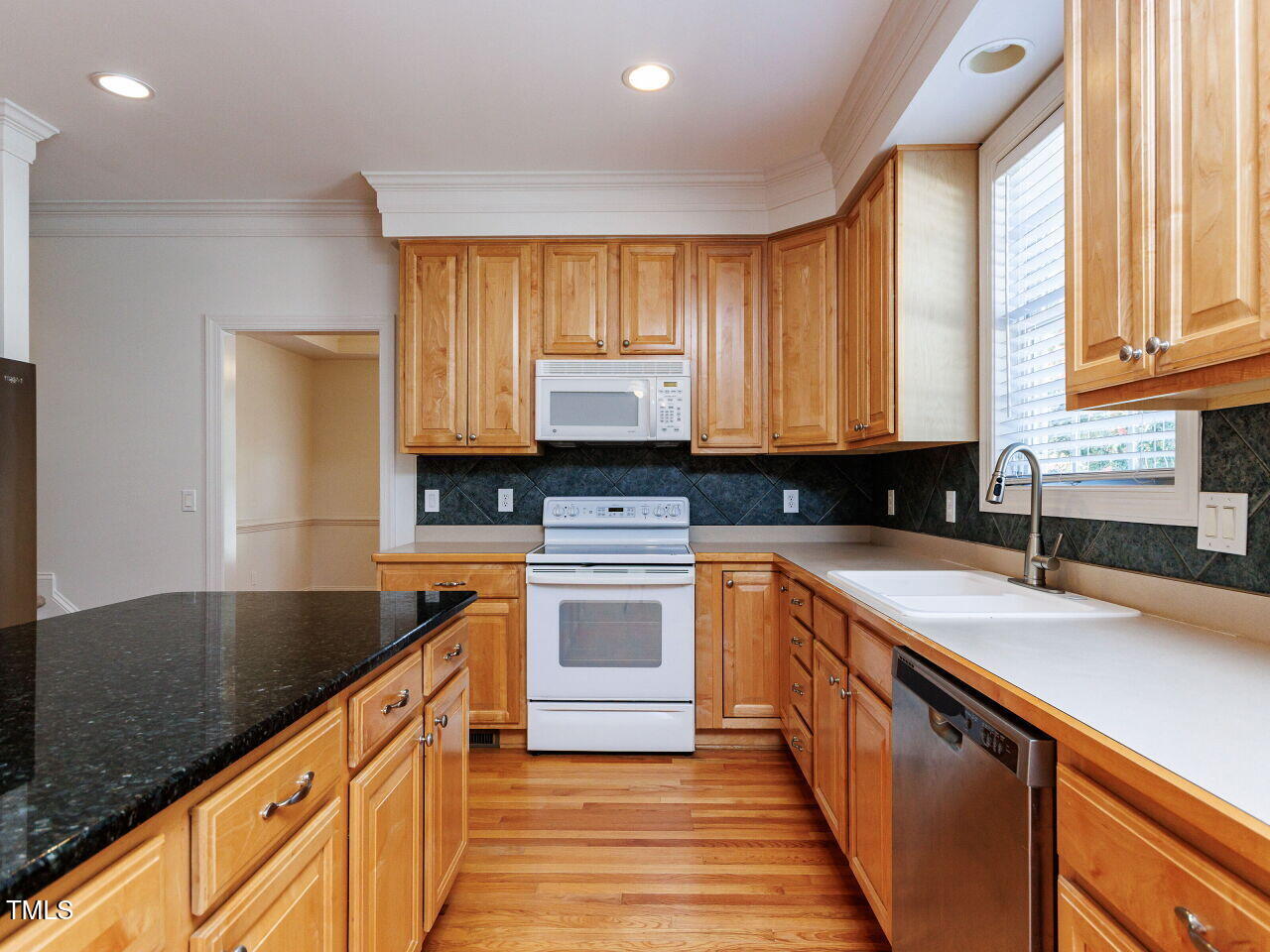 30158 Pharr Chapel Hill, NC 27517 - Photo 16 of 40 a kitchen with granite countertop a sink stove and cabinets