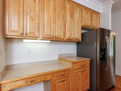 a kitchen with stainless steel appliances granite countertop a refrigerator and cabinets