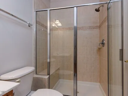a bathroom with a shower a toilet and a sink