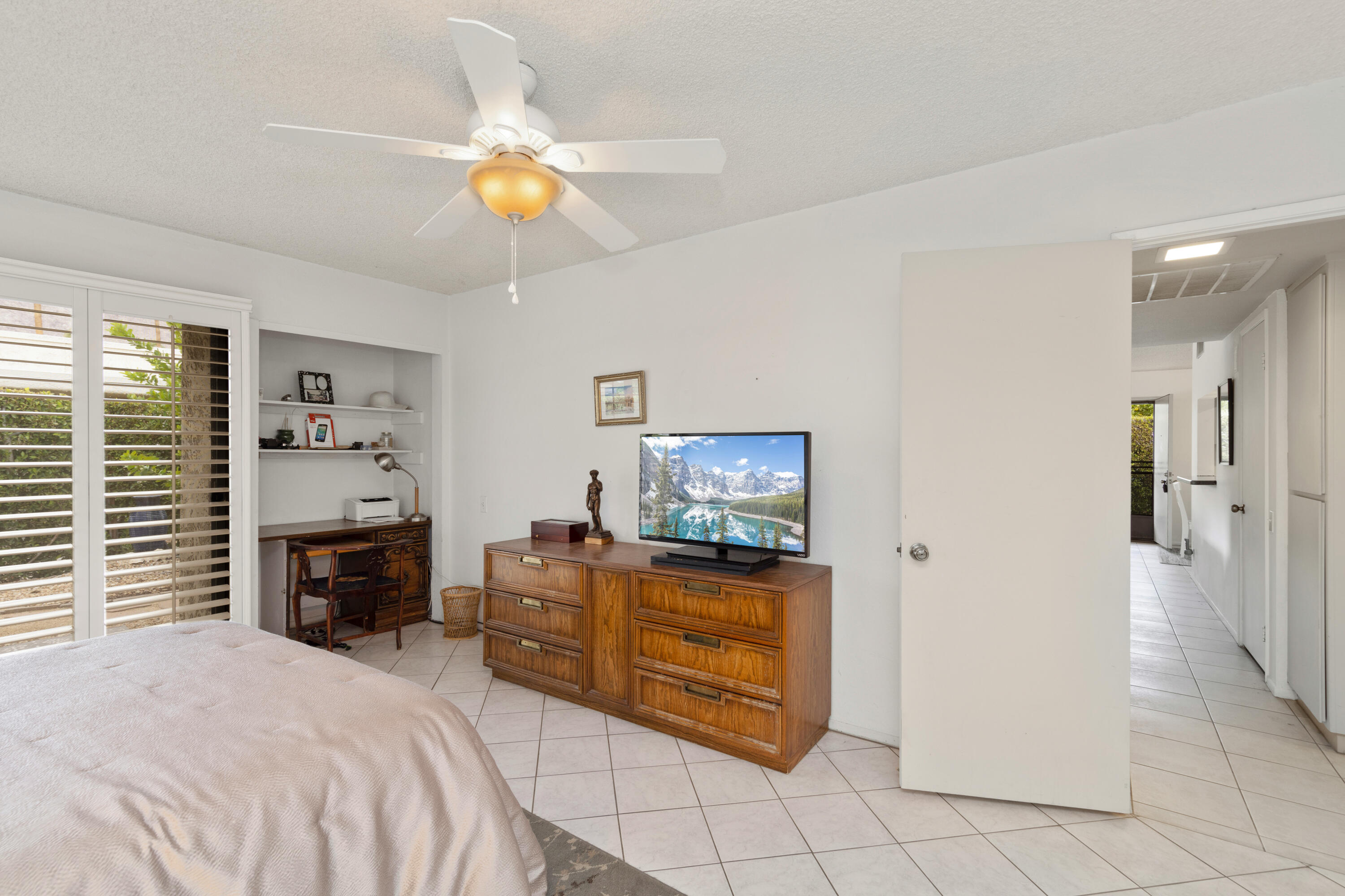 1111 Ramon Road, Unit 28 Palm Springs, CA 92264 - Photo 12 of 28 a bedroom with a bed and a chandelier