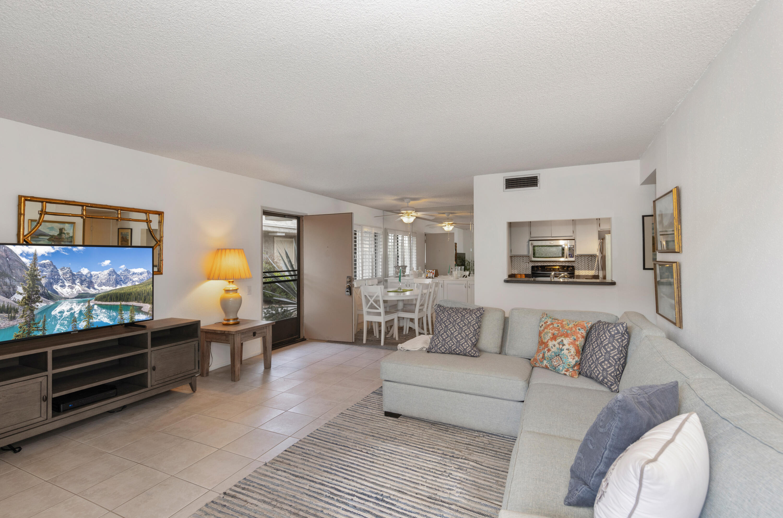 1111 Ramon Road, Unit 28 Palm Springs, CA 92264 - Photo 6 of 28 a living room with furniture and a flat screen tv