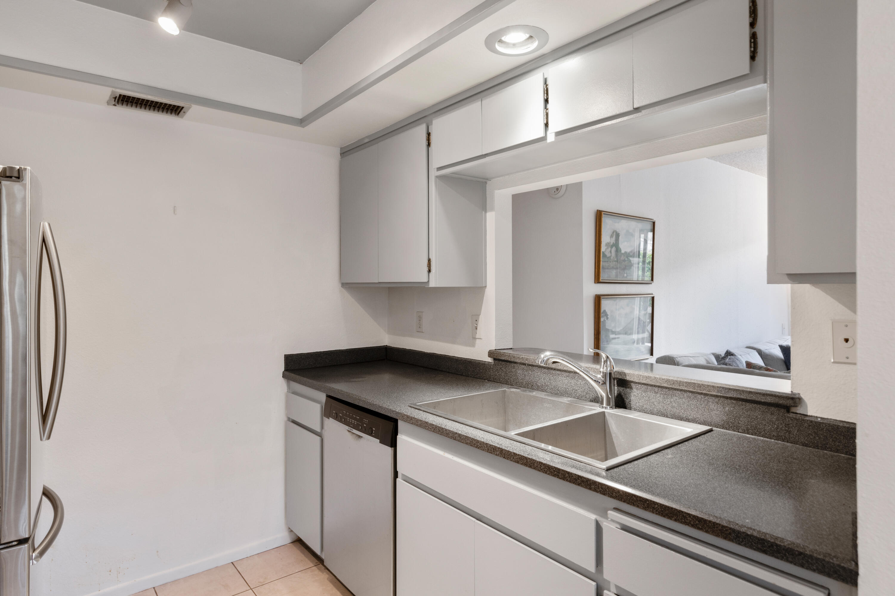1111 Ramon Road, Unit 28 Palm Springs, CA 92264 - Photo 8 of 28 a kitchen with stainless steel appliances granite countertop a sink and a refrigerator