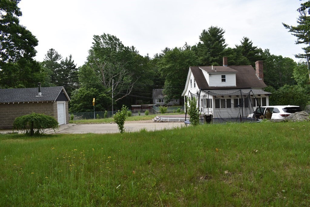 371 Worcester Road Charlton, MA 01507 - Photo 11 of 35 a view of a house with a big yard and large trees