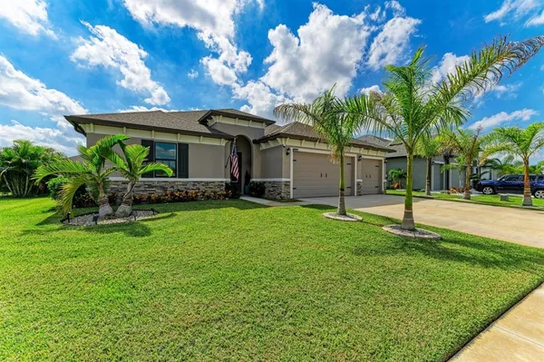 a view of a house with a yard patio and a garden