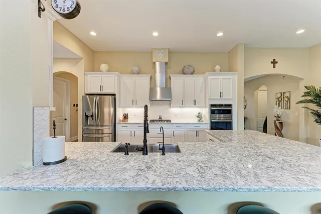 a living room with furniture a chandelier and a window