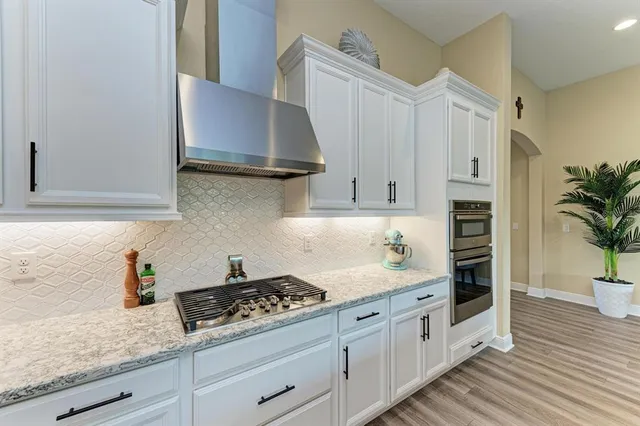a bathroom with a granite countertop sink a toilet and a mirror