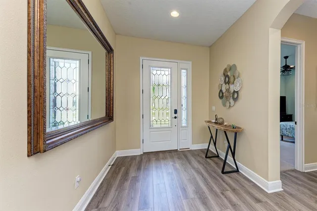 a living room with furniture kitchen view and a chandelier