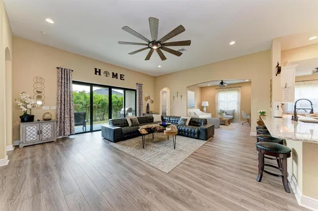 a kitchen with stainless steel appliances kitchen island granite countertop a refrigerator and stove