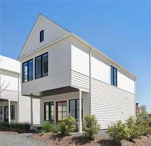 a front view of a house with plants
