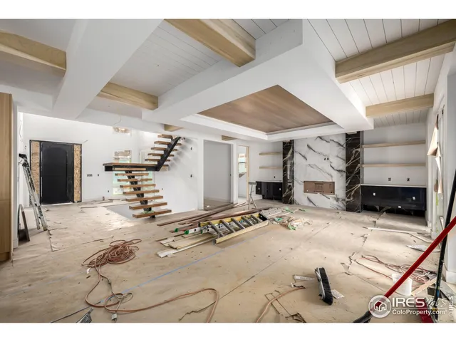 a view of a livingroom with furniture and a kitchen