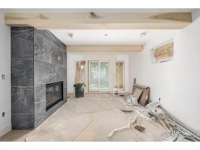 a view of a livingroom with wooden floor and a fireplace