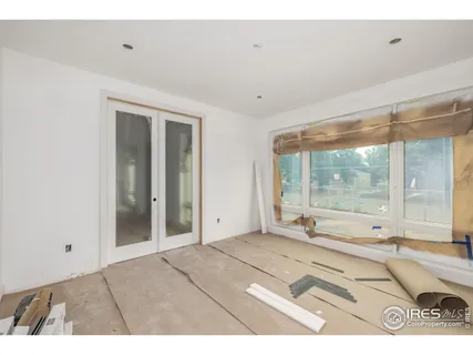 a view of a room with wooden floor and door