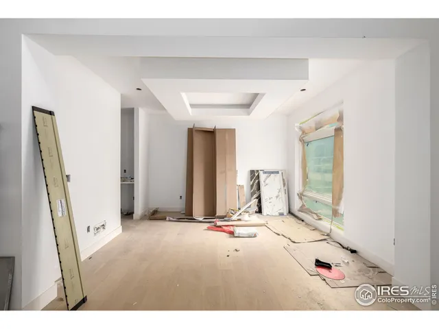 a living room with a mirror and furniture