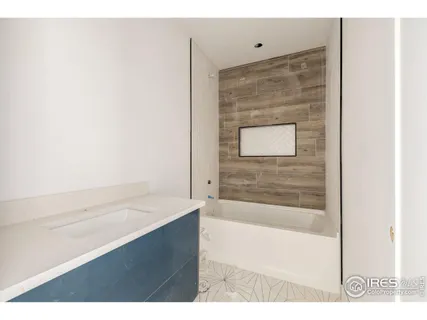 a bathroom with a bathtub and a sink