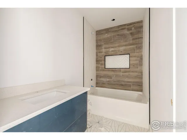 a bathroom with a bathtub and a sink