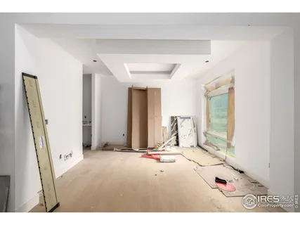 a living room with a mirror and furniture