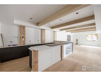 a kitchen with kitchen island sink and cabinets