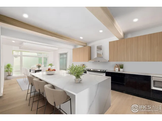 a kitchen with kitchen island a stove a table and chairs