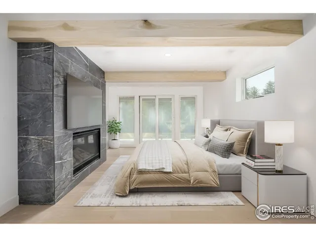 a living room with a bed furniture and a fireplace