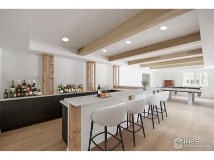 a kitchen with stainless steel appliances granite countertop a table and chairs